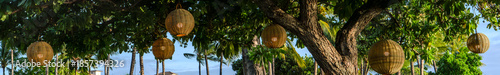 Fényképezés Imagine a stunning display of lanterns beautifully arranged beneath a tree, creating a captivating and enchanting atmosphere that invites you to linger and enjoy the magic of the moment