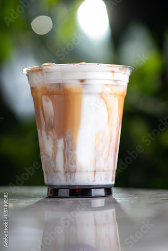 Iced latte a green background with a shadow.