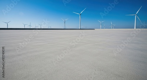 Empty paved expanse, wind turbines