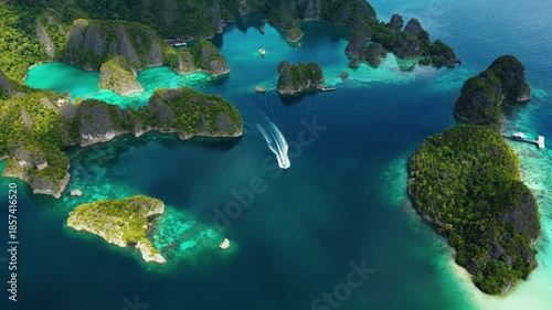 Raja Ampat, Indonesia: Aerial drone footage of a boat leaving the Piaynemo viewpoint famous for its limestone karst landscape in Raja Ampat archipelago in West Papua in Indonesia.