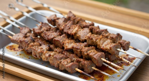 Grilled meat skewers on a tray