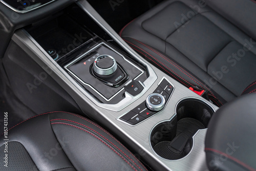 The center console of a sports car with luxury features.