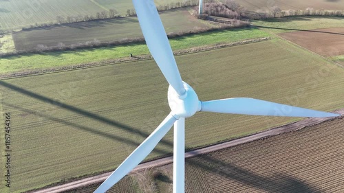 Aerial Wind Turbine Casting Shadow Across Agricultural Fields