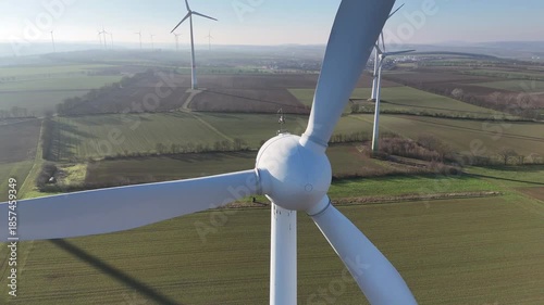 Aerial Wind Turbine Casting Shadow Across Agricultural Fields