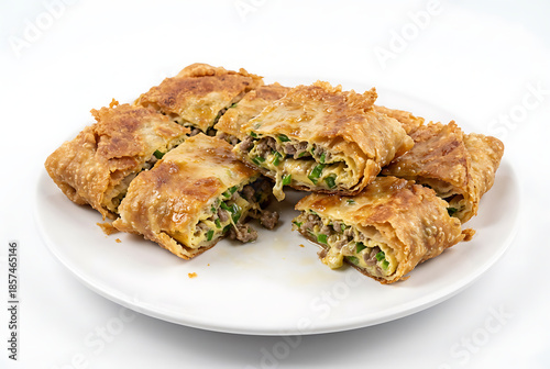 Indonesian martabak asin, whole round martabak telur cut into uneven pieces, on a white plate with white background, suitable for food advertisement