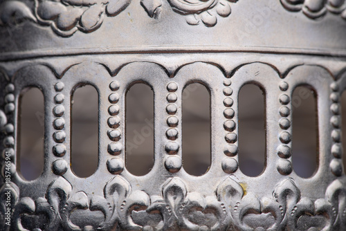 Photos Close-up of details of a Soviet-era tea glass holder with handle featuring a flo