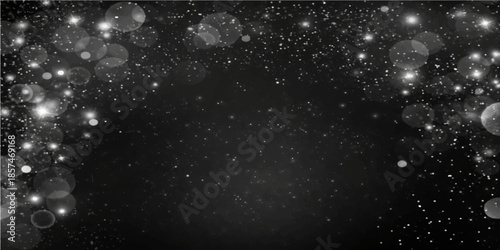 Abstract water drops on a black background resemble a blue galaxy of stars and icy snowflakes across a dark cosmic universe filled with starry night light and winter holiday dust