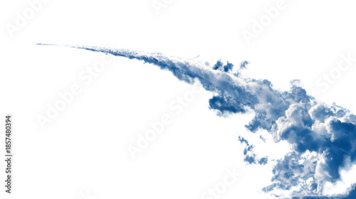 A plane flies through the dark sky leaving a trail of white clouds behind it.