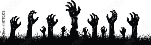Zombie hands reaching out from grassy ground in eerie silhouette