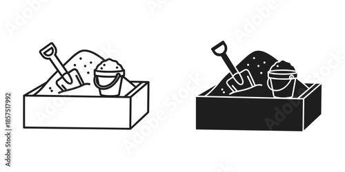 Sand toys in a box with black and white bucket shovel