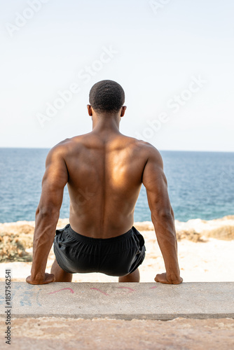 Man doing bench dips. Athletic man doing triceps dips on bench outdoors. 