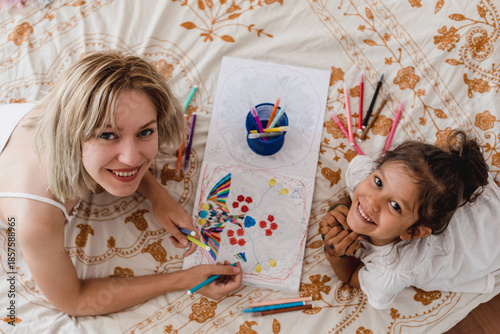 Mother and daughter drawing and smiling