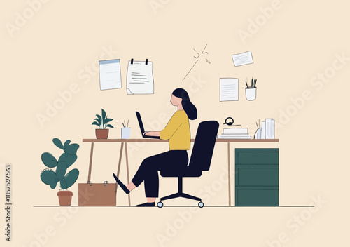 Female office worker sitting at desk using laptop in minimalist workspace with plants, papers, books, and office supplies, modern indoor work environment