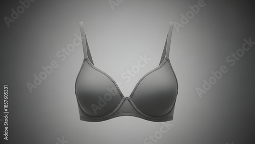 Close-up studio shot of a plain grey women's bra on a gradient background, highlighting its smooth fabric and classic design.