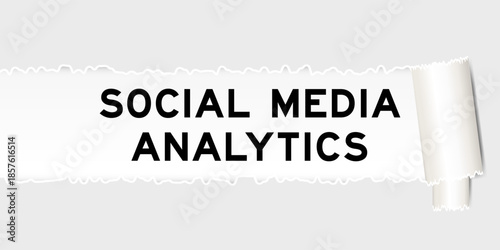 Ripped gray paper background that have word social media analytics under torn part