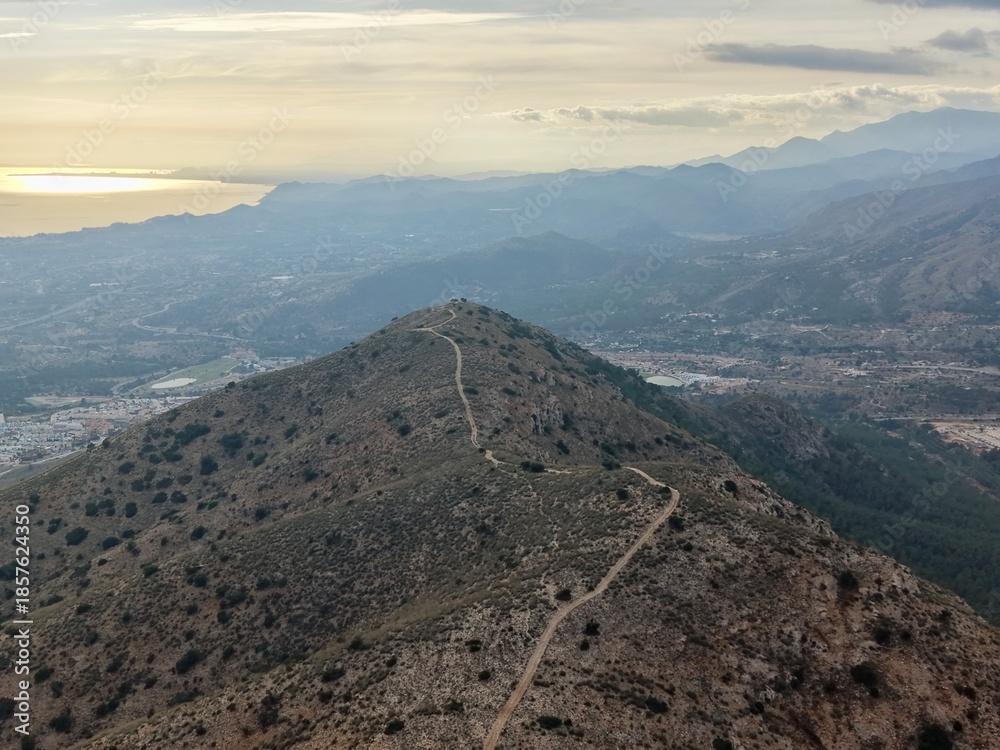 Obraz premium Winding Path Leads To Mountain Outlook, Secluded Trail Offers Breathtaking Scenes Of Ocean And Peaks