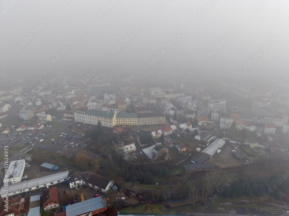Fototapeta premium Misty Neighborhood Scenery, Serene Morning Landscape Featuring Foggy Streets And Reflective Waters
