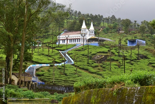 Karumalai Velankanni Church surrounded by misty tea estates and rolling hills in Valparai, showcasing peaceful countryside and nature beauty