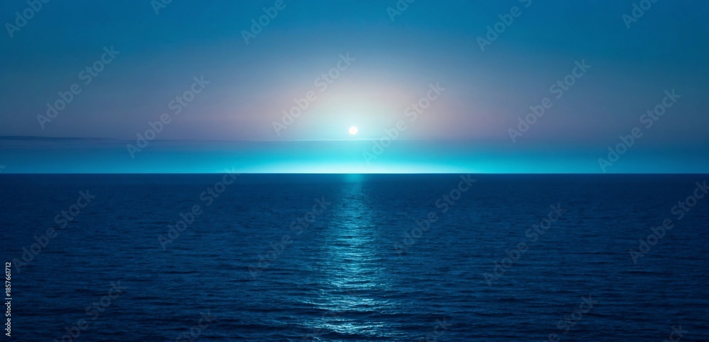 Fototapeta premium Horizon where the ocean meets the sky during a serene twilight with a glowing orb of light
