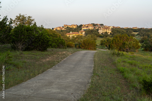 Texas Hill Country living, Mediterranean, Spanish-style architecture upscale houses topping a hill reached by a concrete driveway