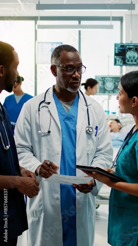 Medical professionals collaborate in a hospital setting, discussing patient care and treatment.