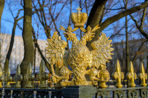 The eagle is mounted on the fence.