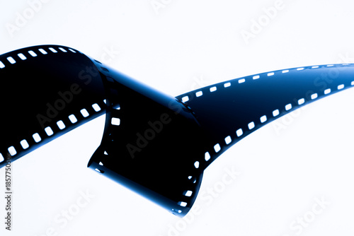 A film strip template with three blank or empty frames, developed 135 type or 35mm film placeholder on white, real film grain