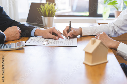 Asian landlord, realtor man pointing on paper for sign signature contract with tenant rental or client, realtor purchase, buyer home or apartment, agreement mortgage, property lease agent concept.
