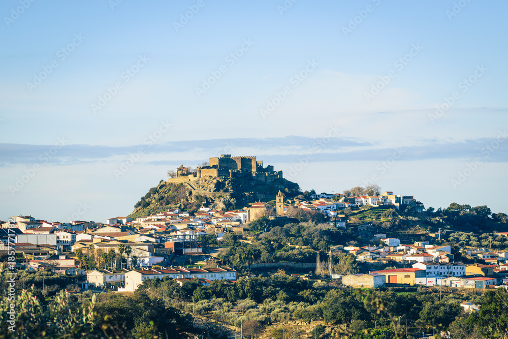 Fototapeta premium Montanchez hilltop castle over white village