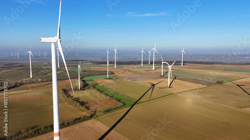 Aerial Wind Turbine Casting Shadow Across Agricultural Fields