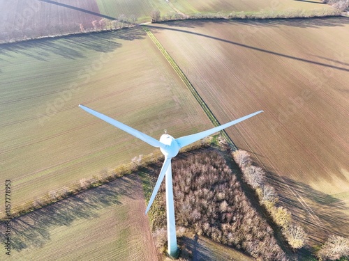 Aerial Wind Turbine Casting Shadow Across Agricultural Fields