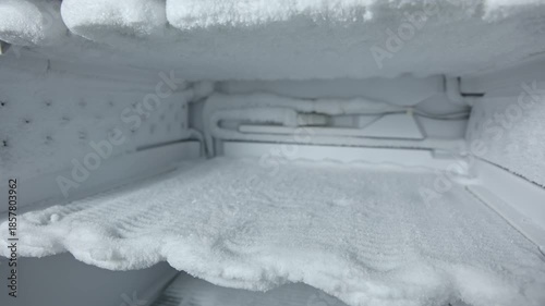 Freezer defrosting process showing gradual removal of ice buildup with visible frost layers and clean interior space transformation