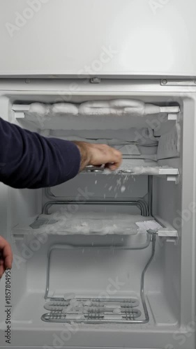 Hand removing ice buildup from freezer shelves while defrosting, showing gradual progress in clearing frost and restoring storage space