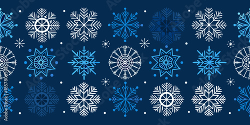A seamless pattern of delicate white and blue winter snowflakes