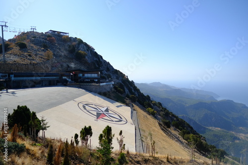 Scenic view of Babadağ, a high mountain and paragliding center overlooking Ölüdeniz and the Mediterranean coast near Fethiye, Turkey.