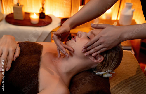 Wallpaper Mural Caucasian woman enjoying relaxing anti-stress head massage and pampering facial beauty skin recreation leisure in warm candle lighting ambient salon spa in luxury resort or hotel. Quiescent Torontodigital.ca