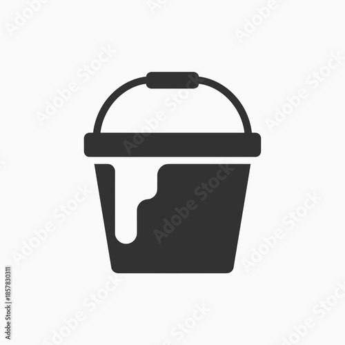 Black paint bucket with dripping paint on a minimalist background  