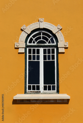 Fotografía Beautiful yellow painted facade and intricate Art Nouveau arched windows with sculpted marble surround