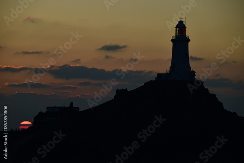 La Corbiere lighthouse, Jersey, U.K. Coastal landmark at sunset.