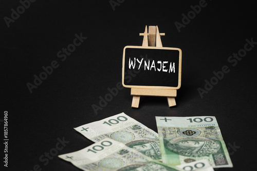 Black wooden writing board on a black background with the inscription 