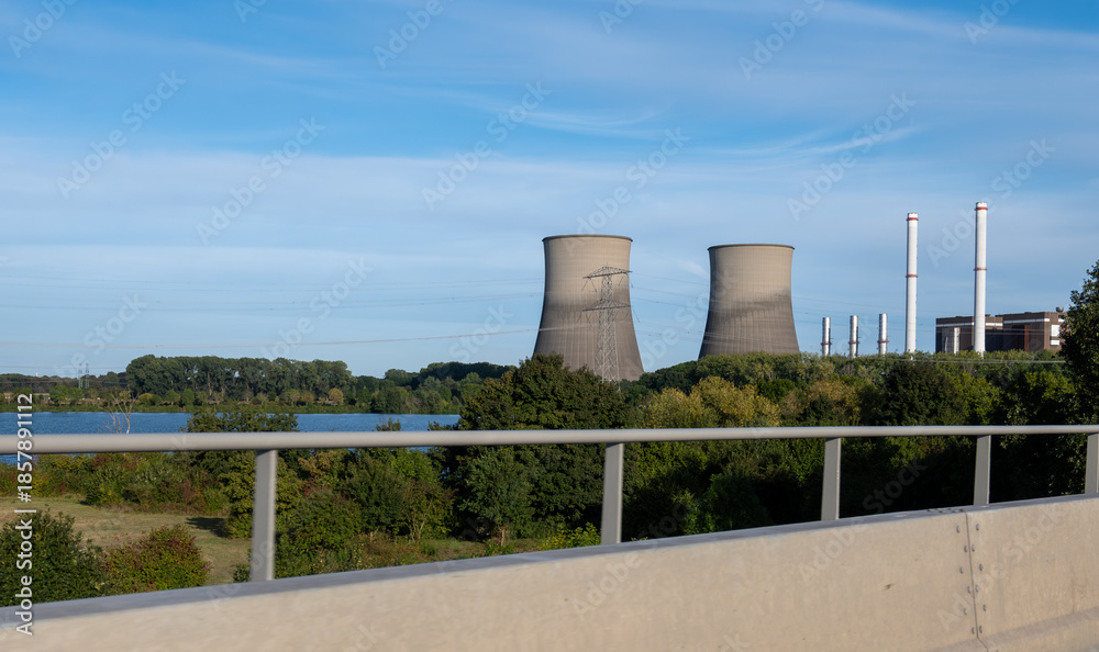 Fototapeta premium Power plant, view on cooling towers located on Maas river, Limburg, The Netherlands, Dutch industry
