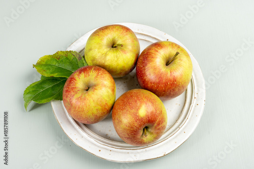 New harvest of french sweet red green apples, tasty healthy fruits on plate