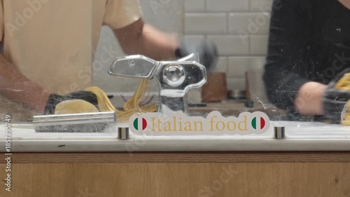 Experienced chef crafting classic homemade spaghetti using a pasta maker in a bustling restaurant kitchen. Witness the art of creating authentic Italian cuisine