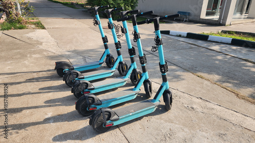 Electric scooters parked on the sidewalk in a city center