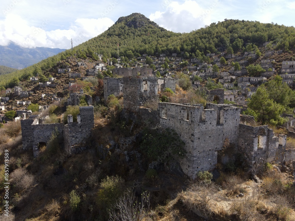 Fototapeta premium Aerial view of Kayaköy, a historic abandoned village set on a hillside near Fethiye, Turkey