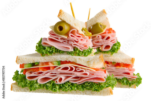 Sandwiches stacked with lettuce, tomatoes, and slices of ham placed on a white background during a meal preparation