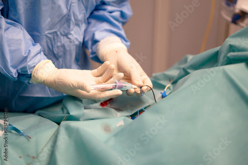 Nurse performing peripheral venous line insertion