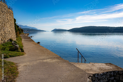 concrete promenade by the sea, clear day without wind, winter, Croatia, Mediterranean