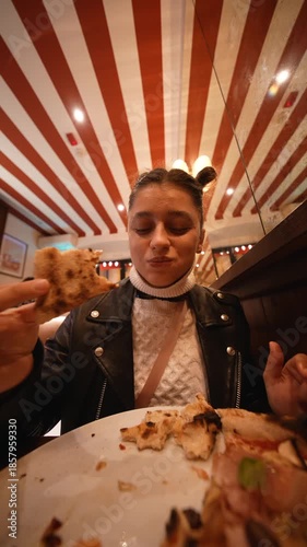 white influencer finishing last pizza bite in retro diner