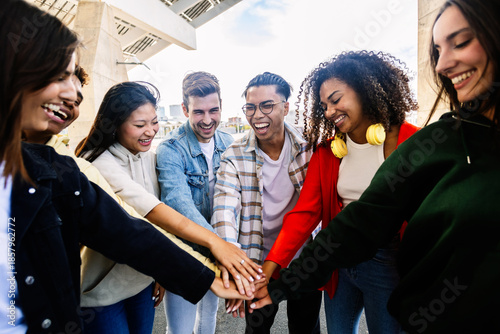Valokuva Happy multiracial friends showing unity by holding hands, enjoying time together in the city